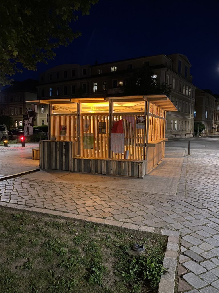 Illuminated wooden pavilion that could be used for workshops.